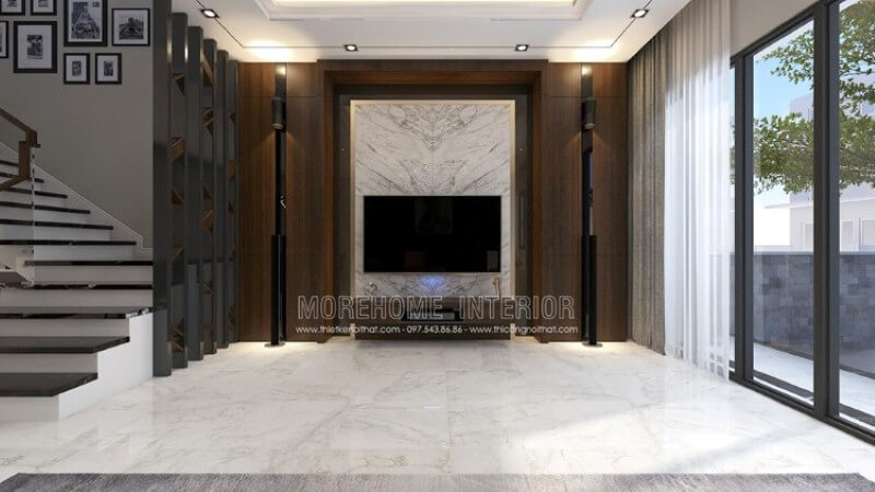 Bố trí nội thất phòng khách đẹp, sang trọng với ý tưởng sử dụng khối đá trắng lớn đối vân ốp tường phòng khách được tôn lên bởi vẻ đẹp trầm từ mảng tường gỗ. Thiết kế phòng khách biệt thự