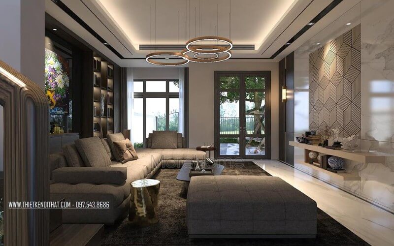Bố trí nội thất phòng khách ấn tượng với cách kết hợp hài hòa giữa sắc trầm và sáng cùng hệ cửa kính lớn giúp không gian trở nên thông thoáng, sang trọng. Thiết kế nội thất phòng khách biệt thự